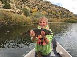 Young girl gets a big trout on the dry fly at the San Juan